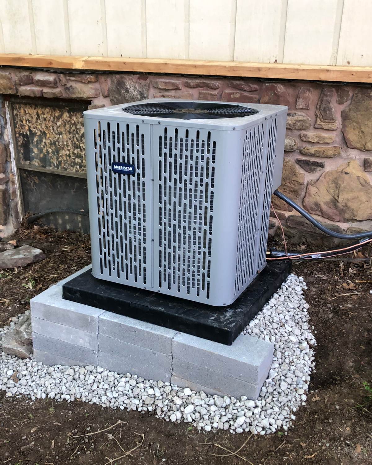 A Franklin technician working on an outdoor AC condenser