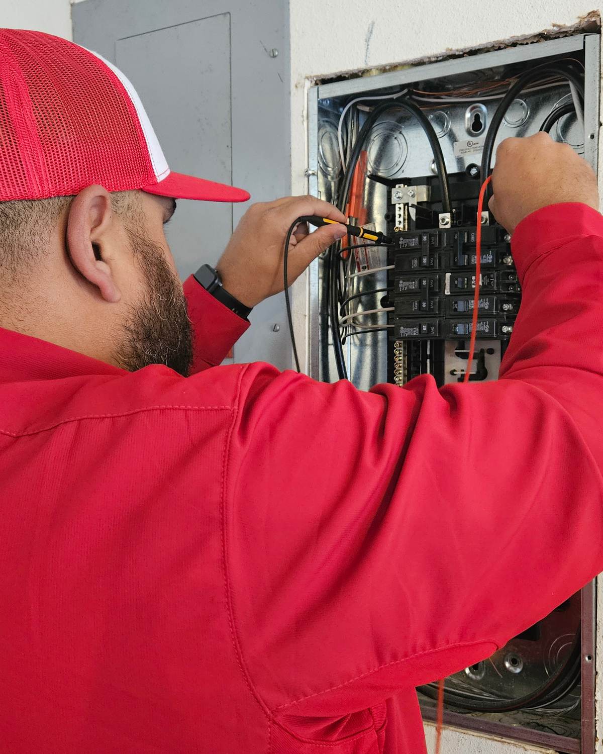A Franklin electrician installing an outlet in a Northwest Arkansas home