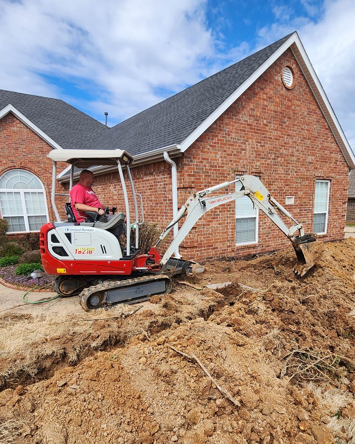 A Franklin plumber repairing a water leak in a Northwest Arkansas home